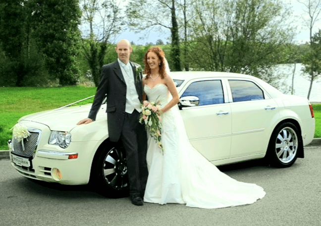 Refined English Bride and Groom standing in front of Bentley Bridal Car 