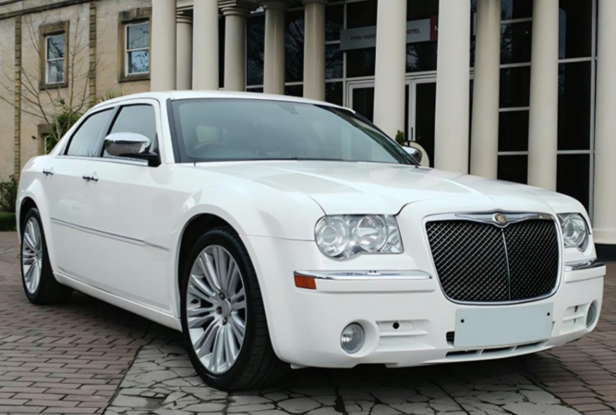 Magnificent White Bently in front of Mansion