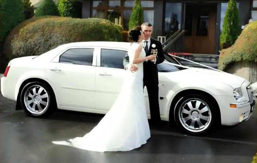 Bride Kissing Groom in Front of luxury white Bentley Bridal Car